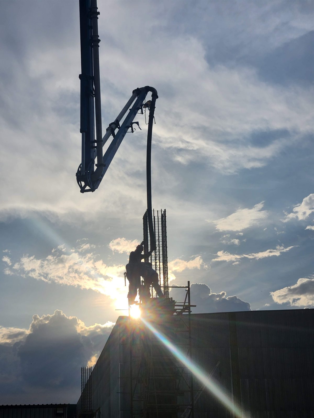 Concrete boom pump placing concrete on a job site